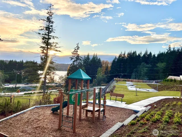 a view of a lake with a table and chairs