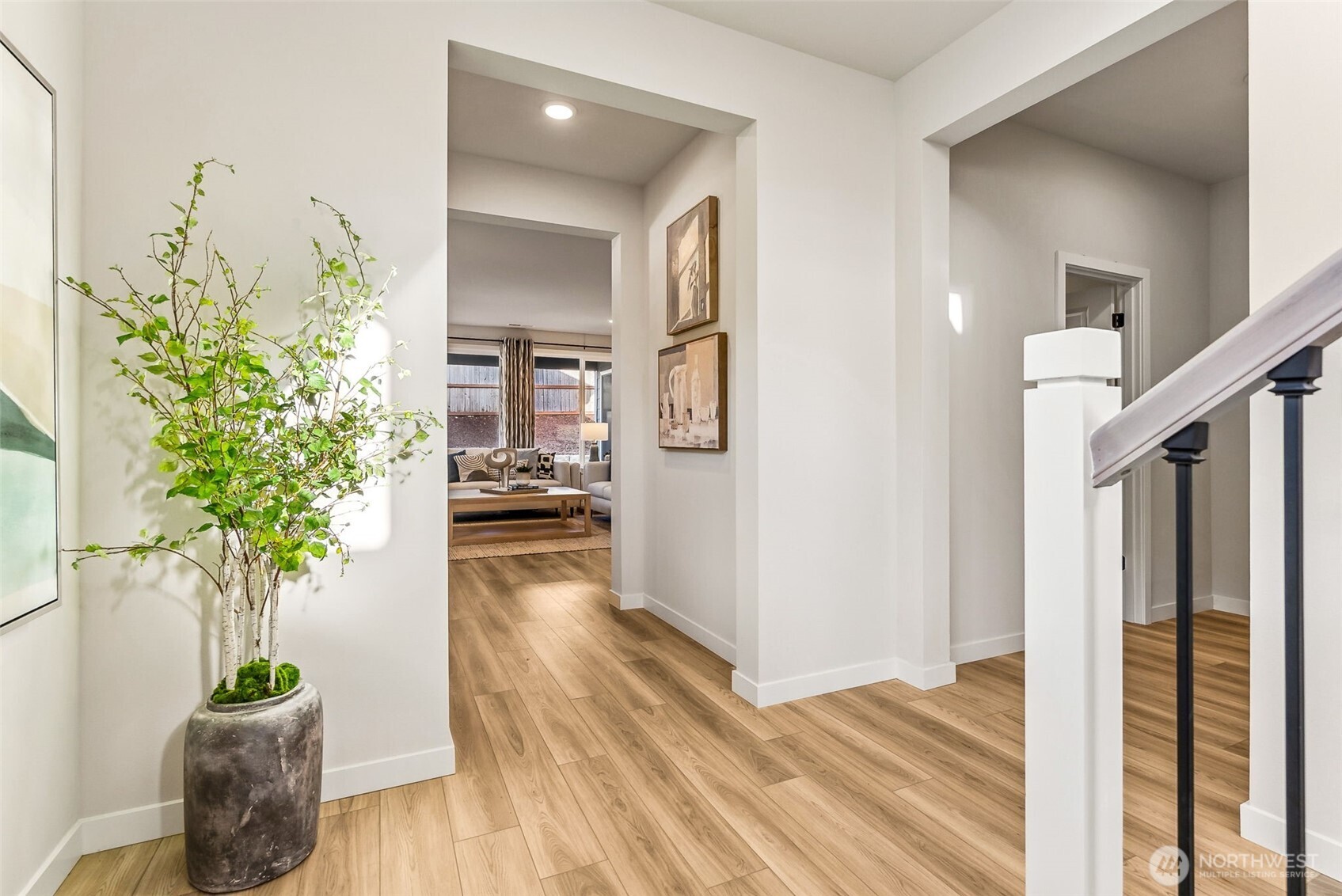 17535 Northeast Midnight Sun Loop Poulsbo, WA 98370 - Photo 6 of 38 a hallway with wooden floor and potted plant