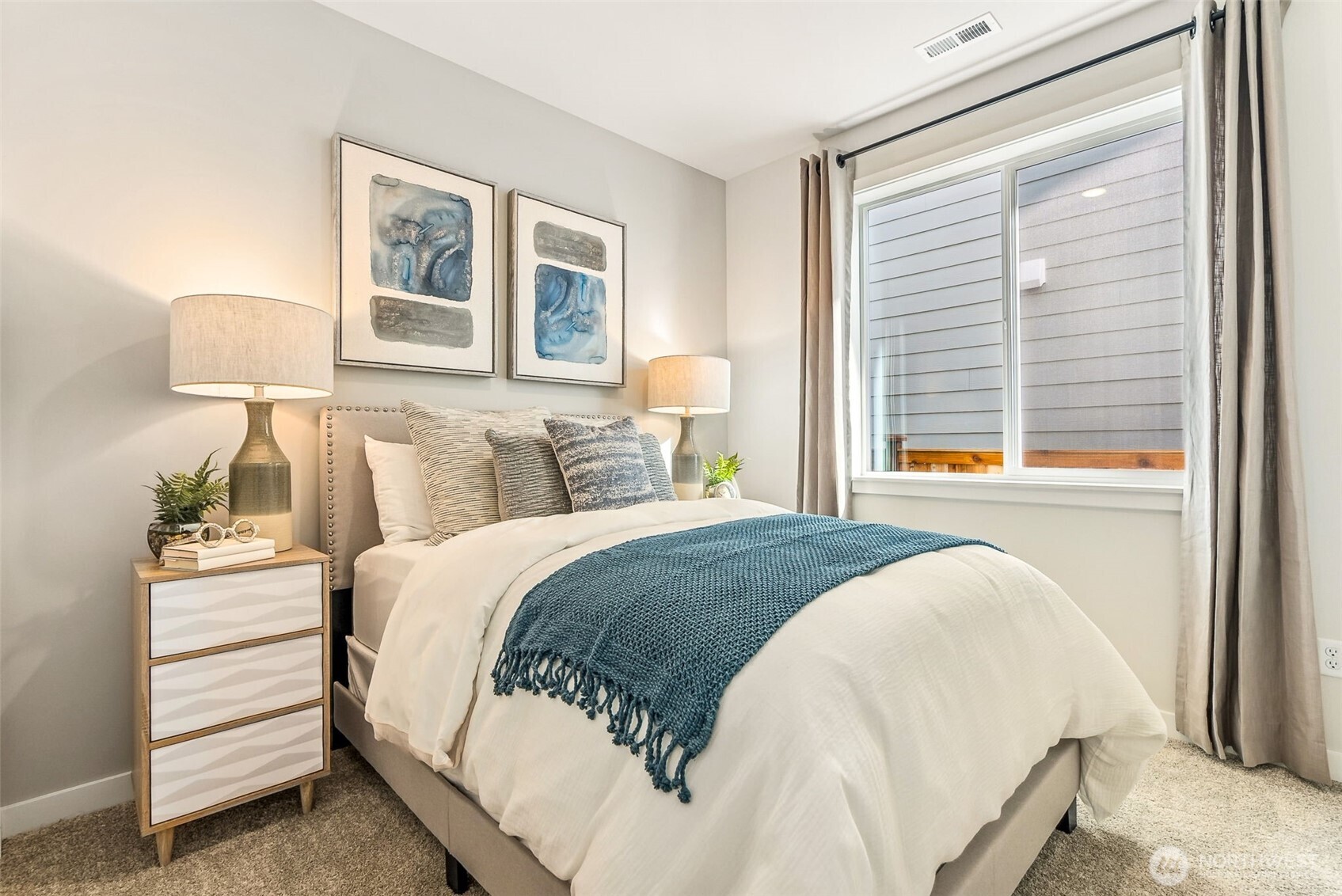 17535 Northeast Midnight Sun Loop Poulsbo, WA 98370 - Photo 8 of 38 a bed sitting in a bedroom next to a window