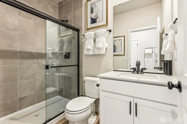 a bathroom with a sink toilet and shower