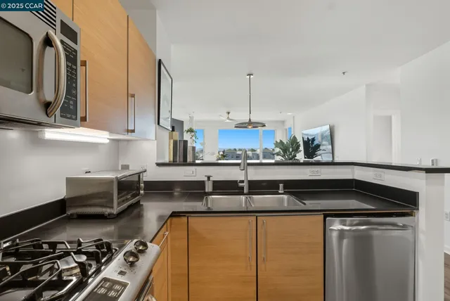 a kitchen with a stove a sink and cabinets