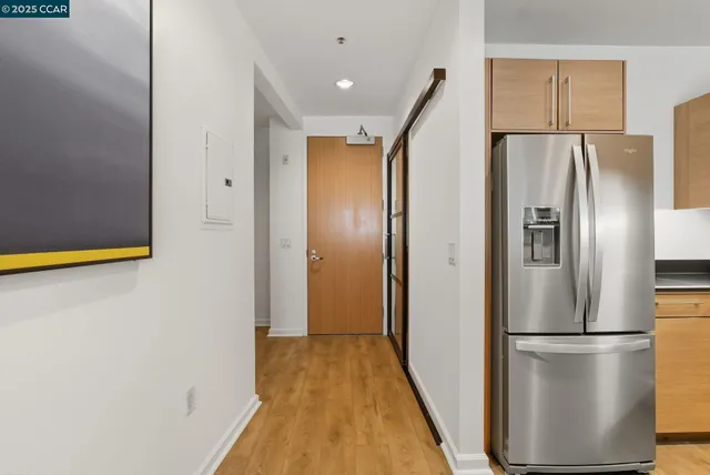 a metallic refrigerator freezer sitting in a kitchen