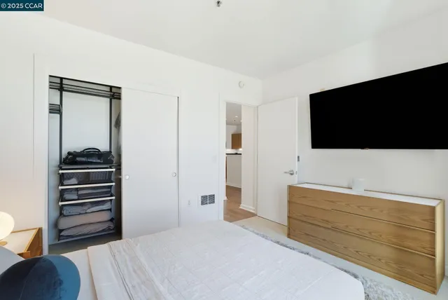 a view of a hallway with chairs and a closet
