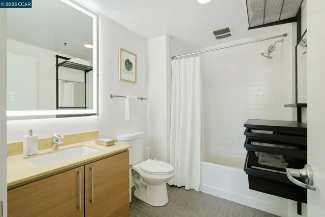 a bathroom with a shower a toilet and a sink