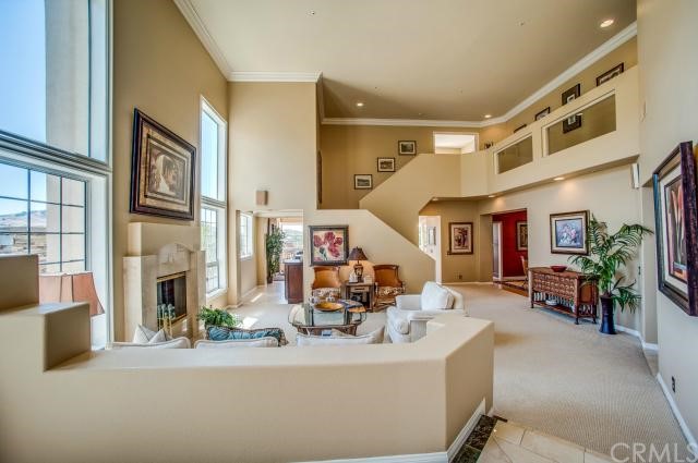 Double Door Entrance to an open 2-story Living Room with Picture Framed Windows to incredible views.