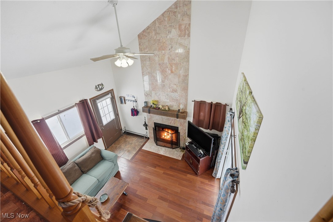 4254 Doral Road Southwest Carrollton, OH 44615 - Photo 36 of 46 Living area with high vaulted ceiling, a fireplace, wood finished floors, ceiling fan