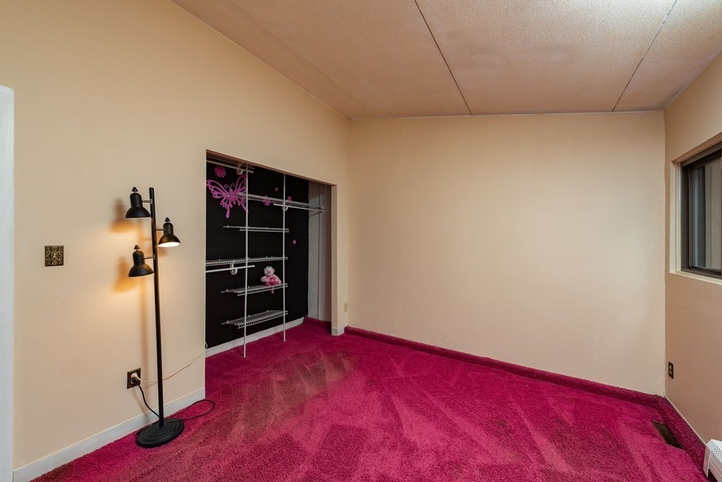 4 Raintree Circle, Unit 4D Brockton, MA 02302 - Photo 11 of 24 a view of empty room with wooden floor and closet