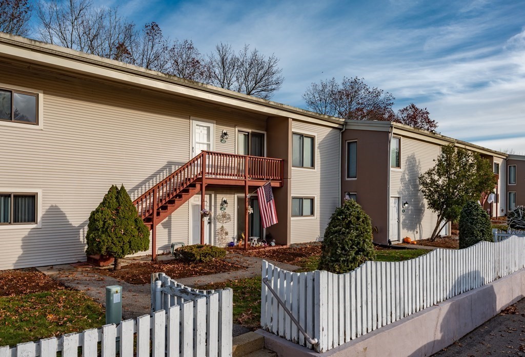 4 Raintree Circle, Unit 4D Brockton, MA 02302 - Photo 2 of 24 a front view of house yard with wooden fence