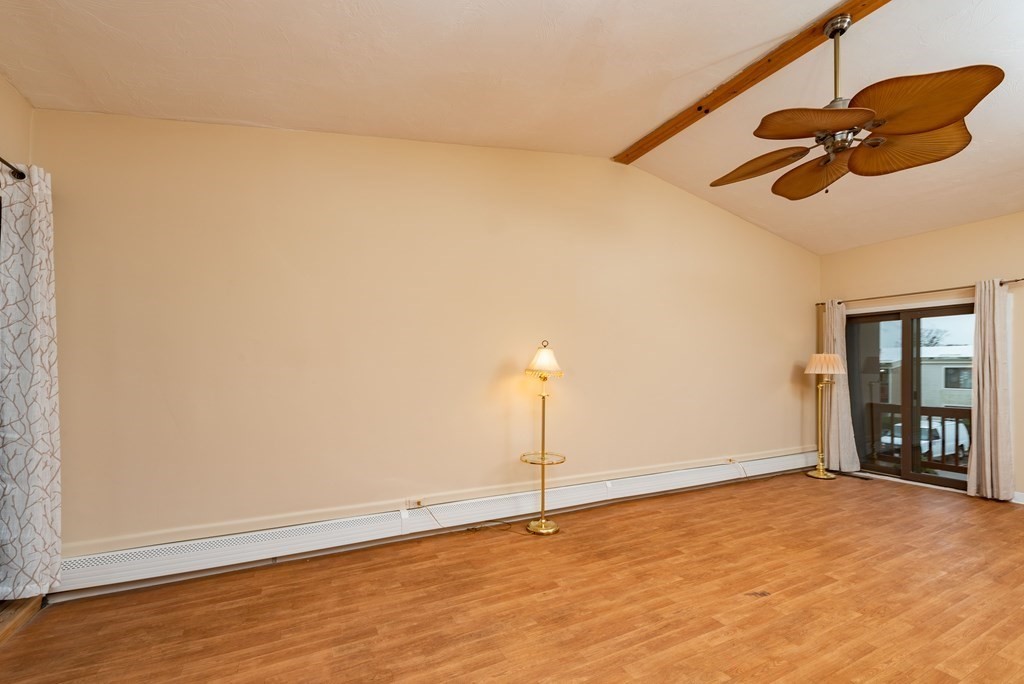 4 Raintree Circle, Unit 4D Brockton, MA 02302 - Photo 23 of 24 an empty room with ceiling fan and window