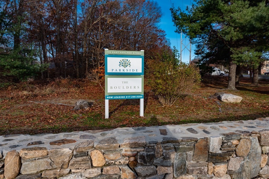 4 Raintree Circle, Unit 4D Brockton, MA 02302 - Photo 24 of 24 a sign board with wooden fence