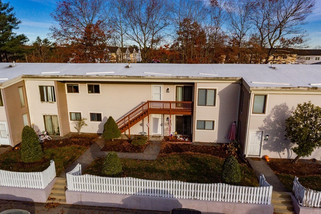 4 Raintree Circle, Unit 4D Brockton, MA 02302 - Photo 3 of 24 a front view of house with yard and trees in the background