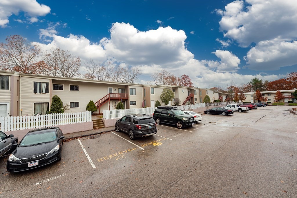 4 Raintree Circle, Unit 4D Brockton, MA 02302 - Photo 4 of 24 a car parked in front of a house