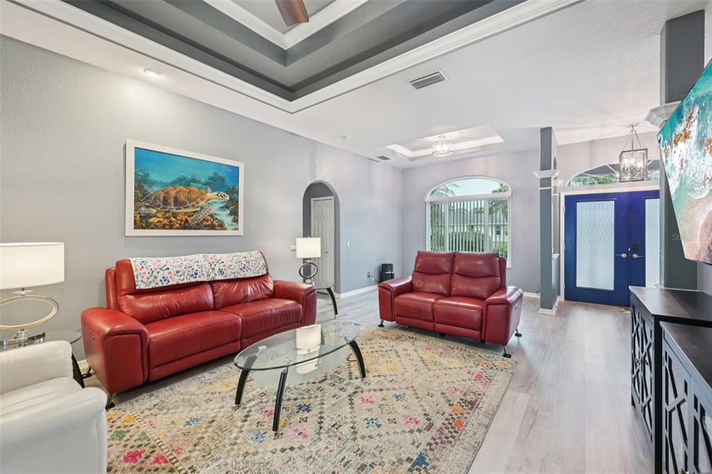 4337 Langsom Lane North Port, FL 34286 - Photo 11 of 42 a living room with furniture a rug and a floor to ceiling window