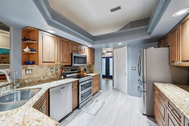 a kitchen with a sink stove and refrigerator