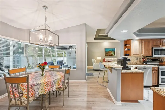 a view of a dining room and livingroom furniture kitchen and a chandelier