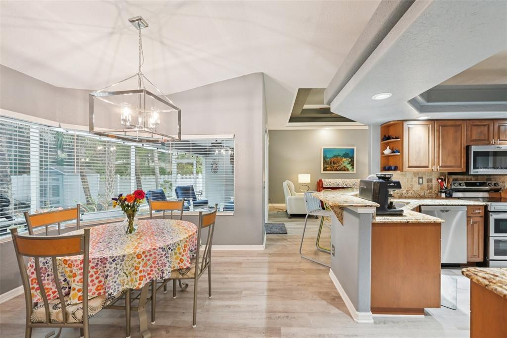 4337 Langsom Lane North Port, FL 34286 - Photo 17 of 42 a view of a dining room and livingroom furniture kitchen and a chandelier