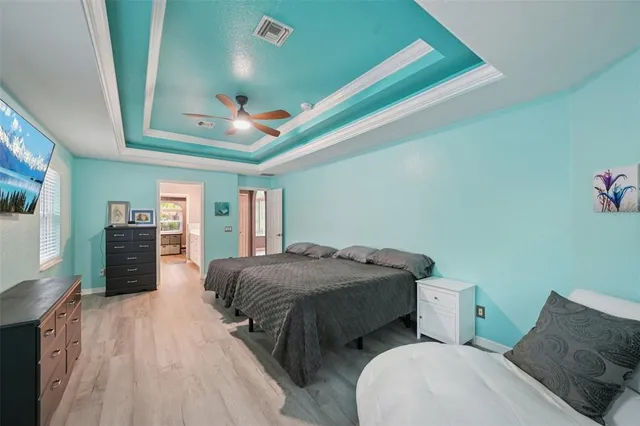 a bedroom with two beds and a chandelier