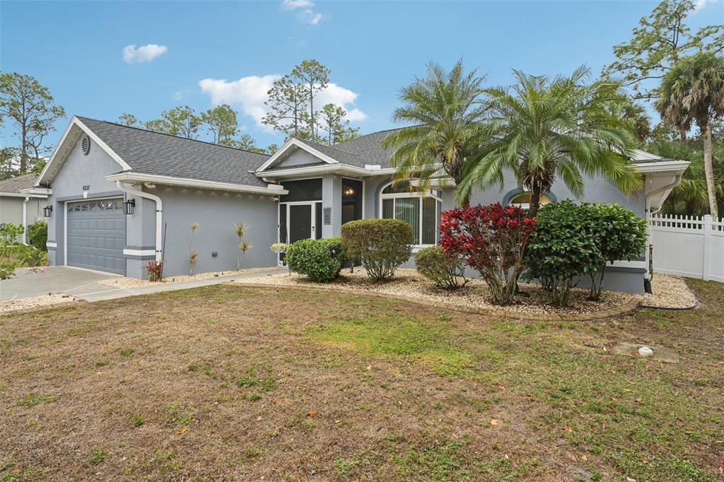 4337 Langsom Lane North Port, FL 34286 - Photo 2 of 42 a front view of house with yard and trees around