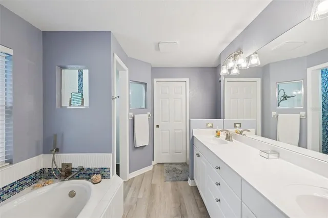 a spacious bathroom with a double vanity sink mirror and double