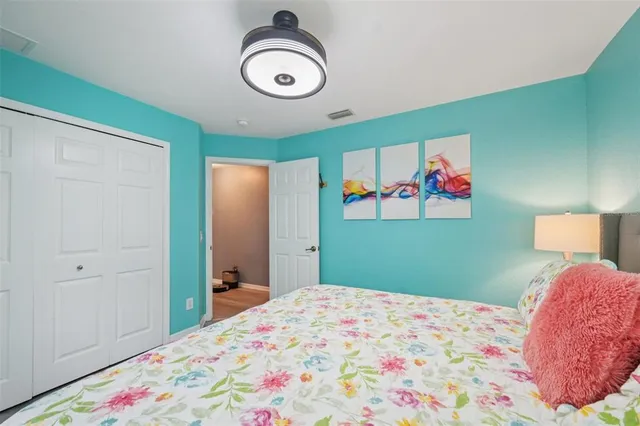 a bedroom with a bed and a chandelier