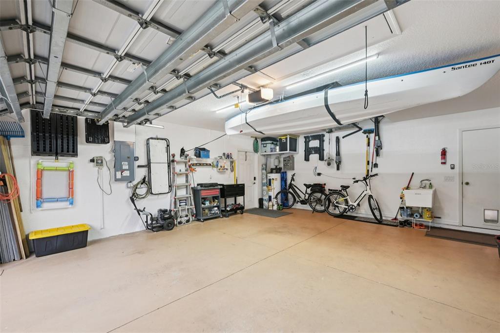 4337 Langsom Lane North Port, FL 34286 - Photo 33 of 42 a view of a garage with a bike and white walls