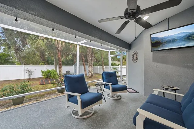 a living room with furniture and a floor to ceiling window