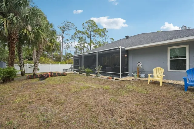 a view of a house with backyard and sitting area