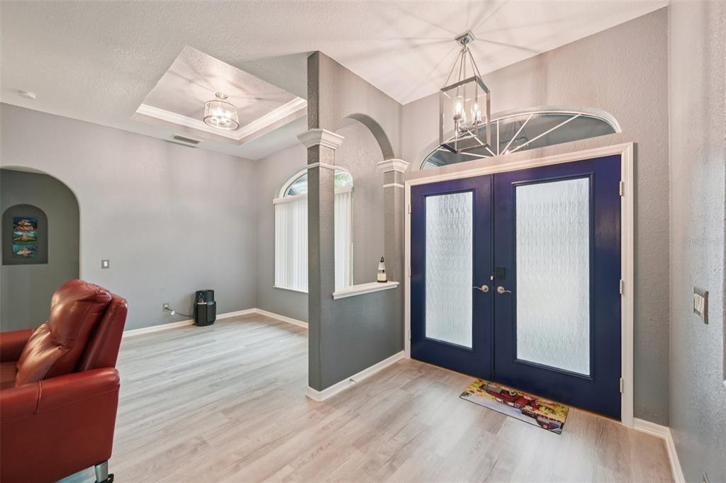 4337 Langsom Lane North Port, FL 34286 - Photo 8 of 42 a hallway with couches and wooden floor