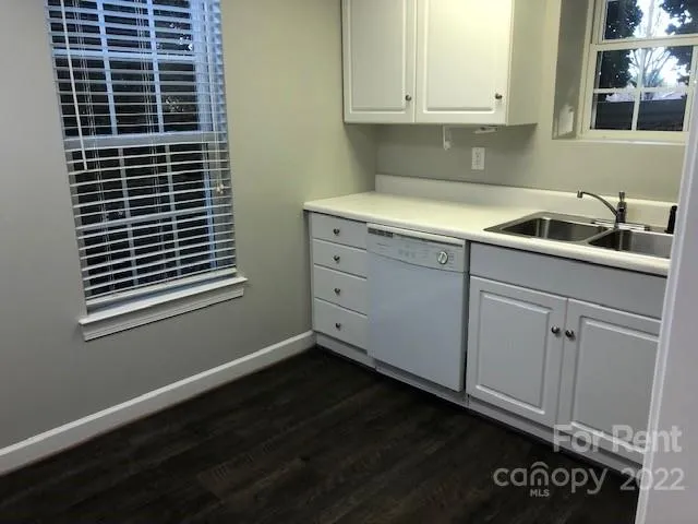a kitchen with a sink and cabinets