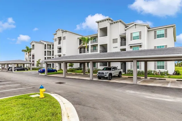 a kitchen with a sink a stove a refrigerator and white cabinets with wooden floor