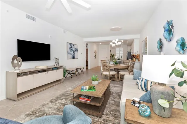 a living room with furniture and a potted plant