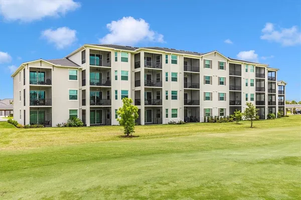 a front view of a house with glass windows and furniture