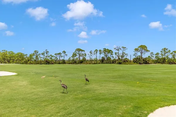 a view of a room with gym equipment and a large window