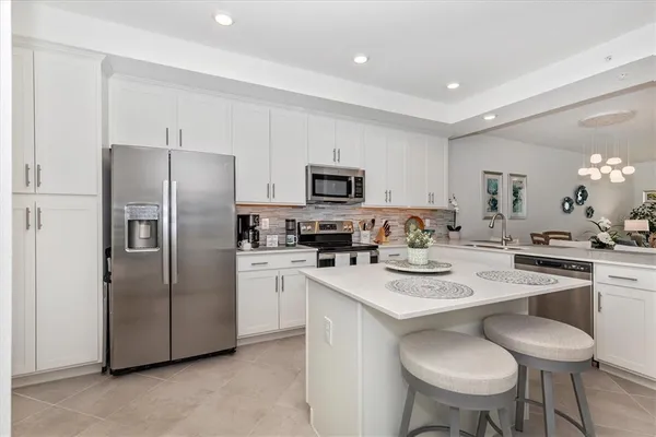 a kitchen with stainless steel appliances granite countertop a sink and cabinets