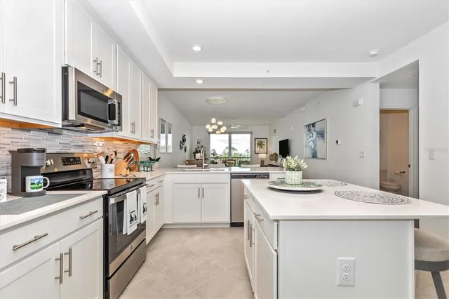 a kitchen with stainless steel appliances granite countertop a refrigerator stove and sink
