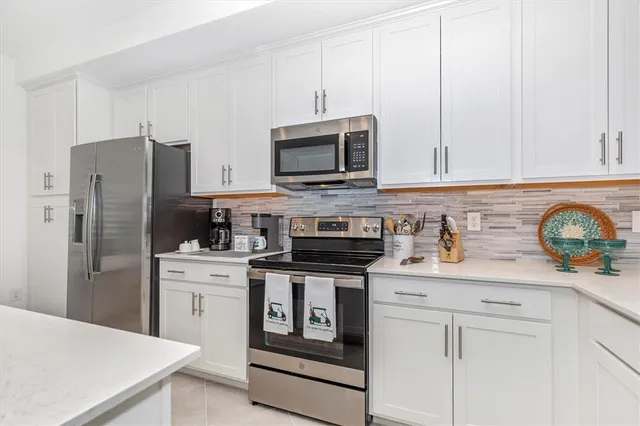 a kitchen that has a sink and a refrigerator in it