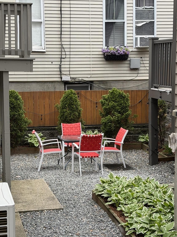 26 Brooks Street, Unit 2 Boston, MA 02128 - Photo 11 of 12 a backyard of a house with outdoor seating