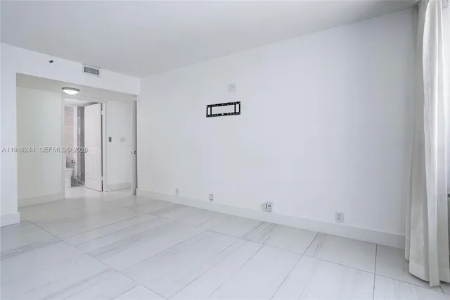 a view of a balcony with wooden benches