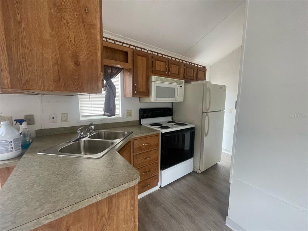 3000 Clarcona Road, Unit 830 Apopka, FL 32703 - Photo 11 of 28 a kitchen with stainless steel appliances granite countertop a sink stove and refrigerator