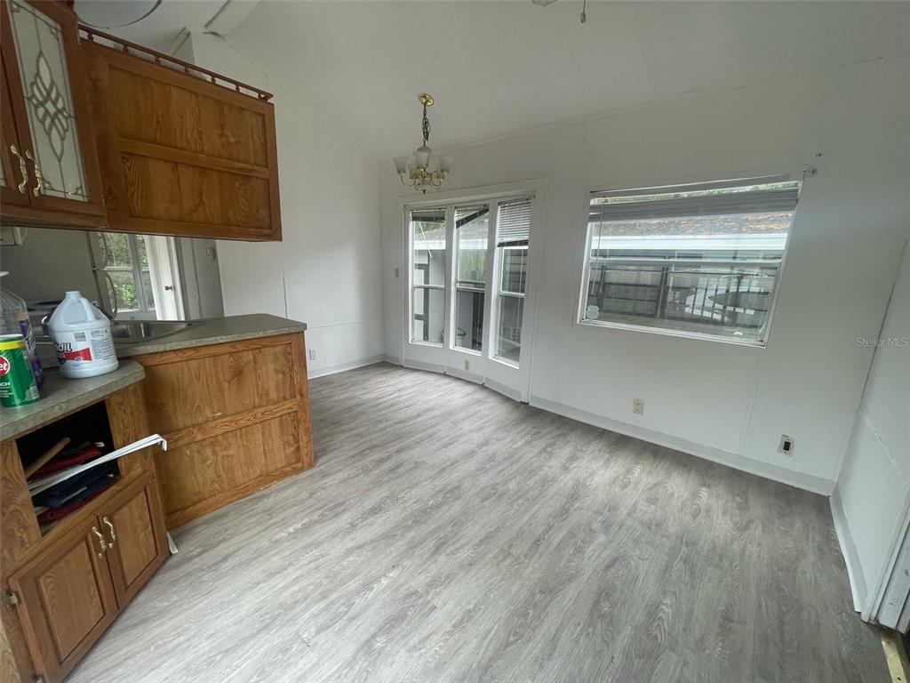 3000 Clarcona Road, Unit 830 Apopka, FL 32703 - Photo 13 of 28 a kitchen with wooden floors and cabinets