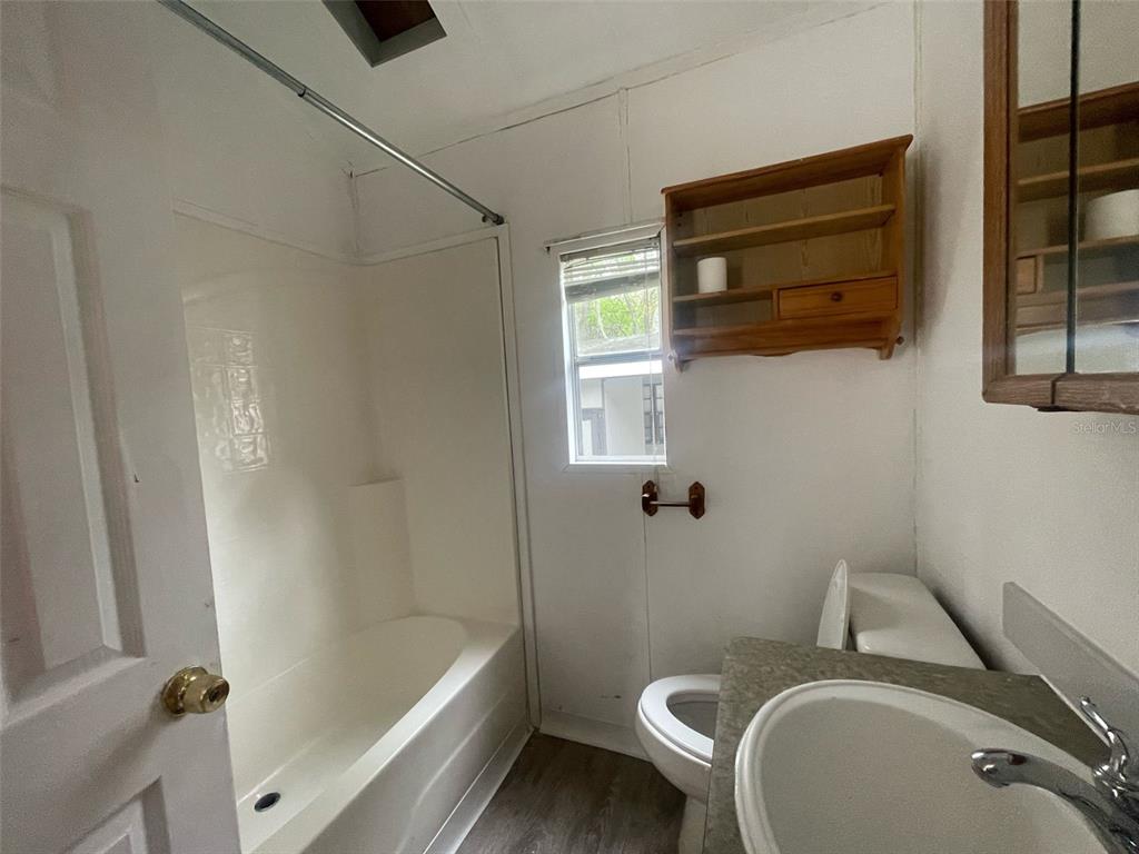 3000 Clarcona Road, Unit 830 Apopka, FL 32703 - Photo 14 of 28 a bathroom with a sink a toilet and bathtub