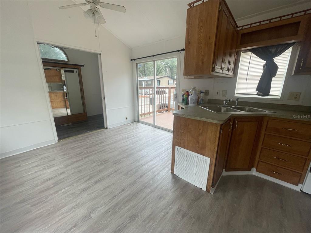 3000 Clarcona Road, Unit 830 Apopka, FL 32703 - Photo 5 of 28 a kitchen with stainless steel appliances granite countertop a stove a sink and a refrigerator