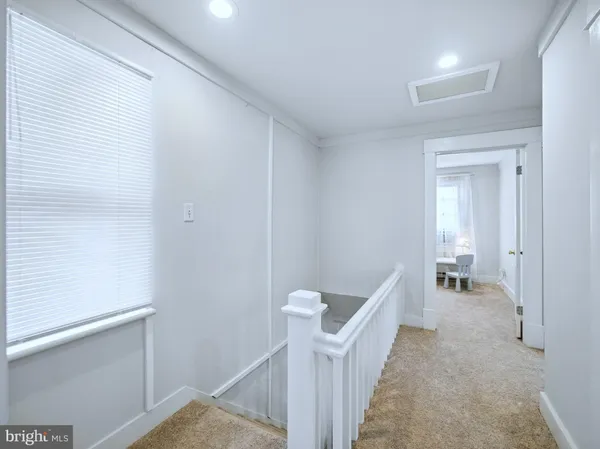 a kitchen with refrigerator and white cabinets