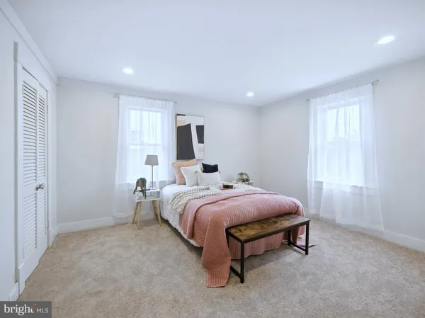 a living room with furniture rug and wooden floor
