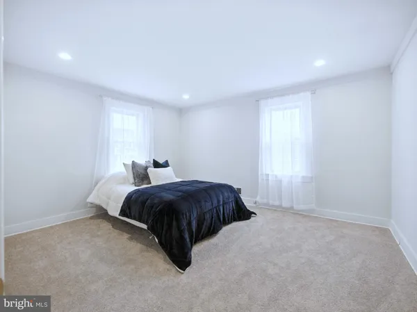 a bathroom with a bathtub a sink and a mirror