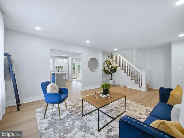 a living room with furniture rug and wooden floor