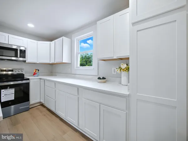 a kitchen with stainless steel appliances granite countertop a refrigerator sink and cabinets
