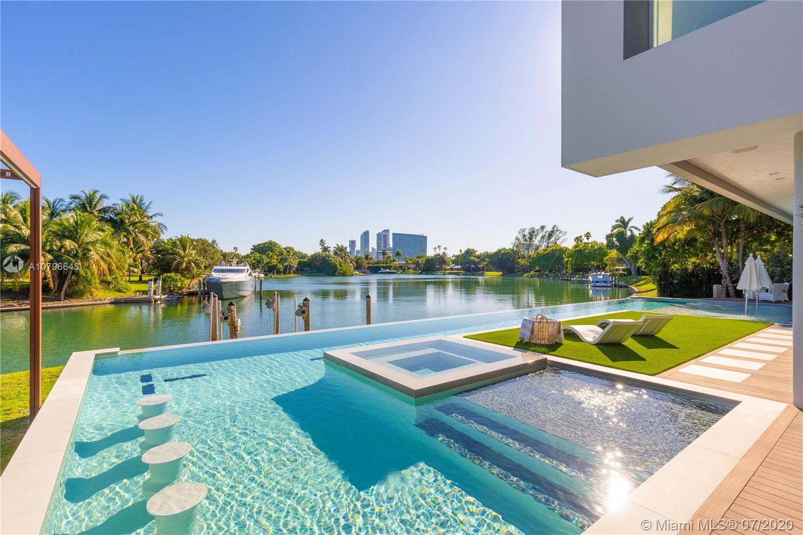 4731 Lake Road Miami, FL 33137 - Photo 2 of 46 a view of a lake with couches chairs and a table