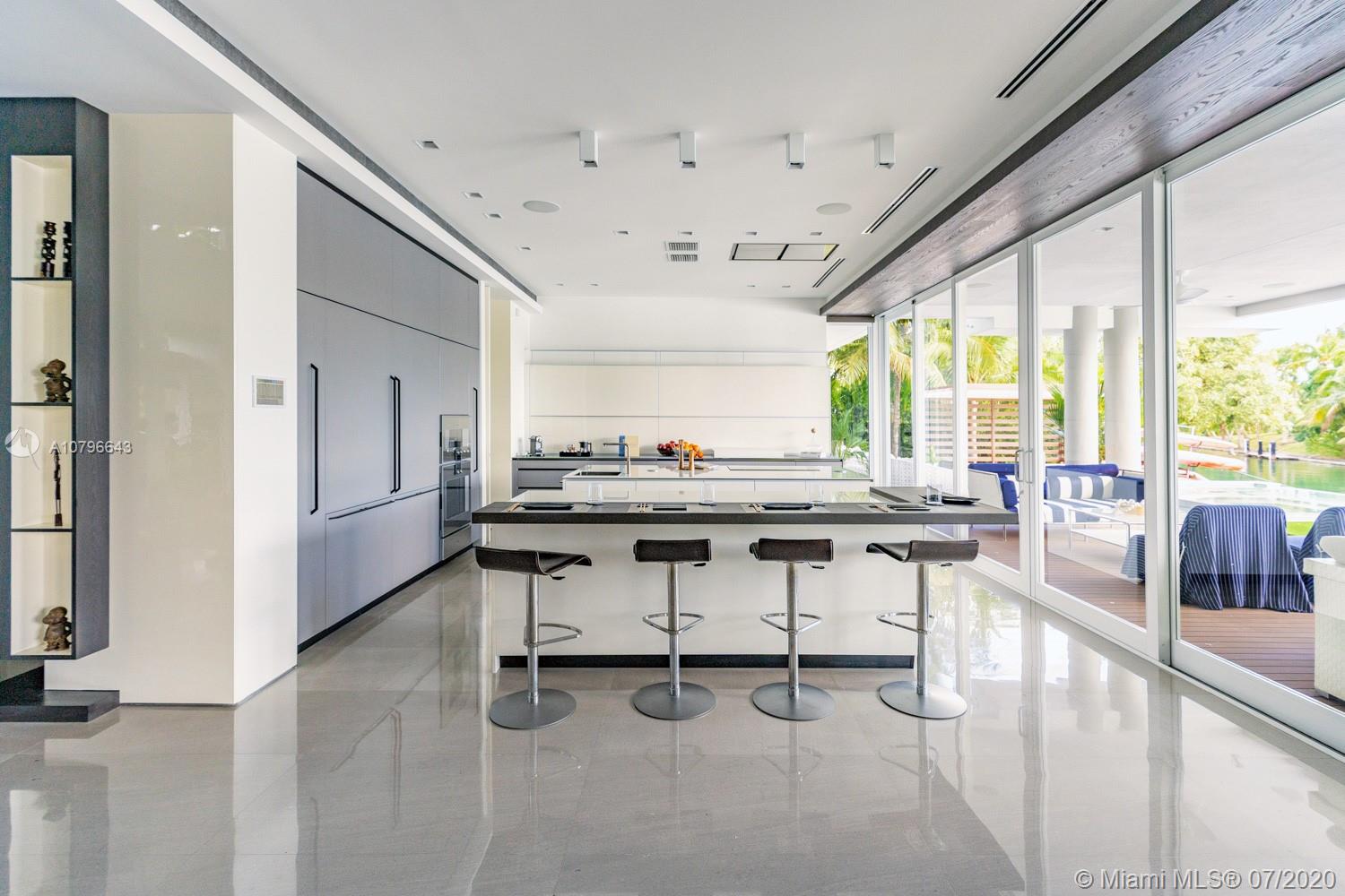 4731 Lake Road Miami, FL 33137 - Photo 11 of 46 a view of a dining room with furniture and a floor to ceiling window