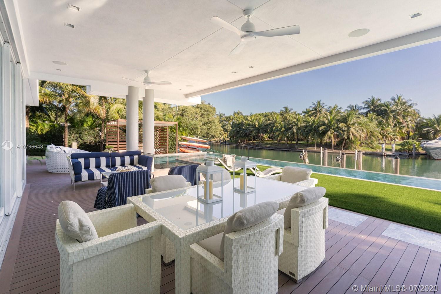 4731 Lake Road Miami, FL 33137 - Photo 17 of 46 a dining room with furniture and a floor to ceiling window